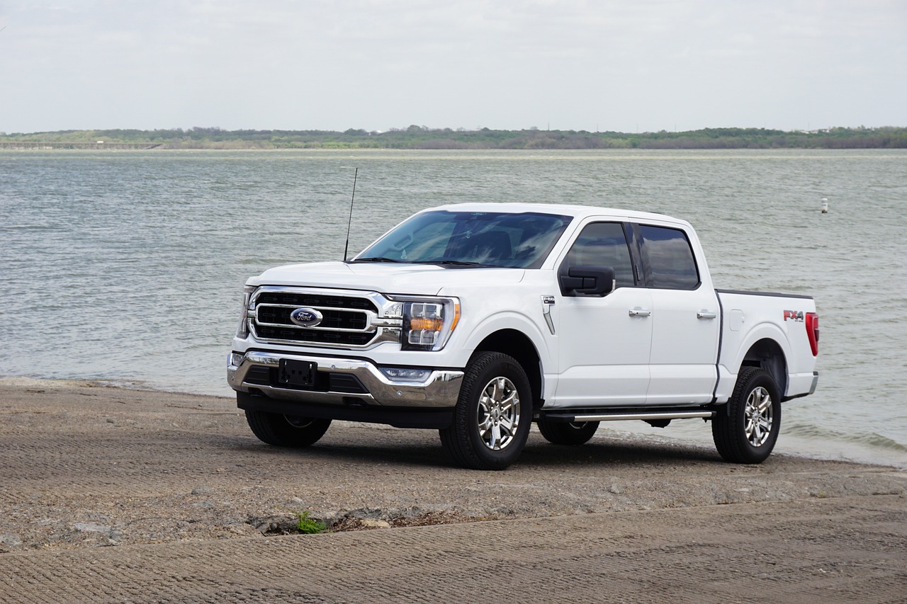 White Ford pickup truck on a beach