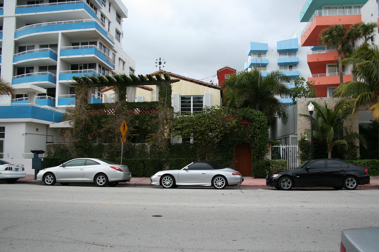 Cars parked in front of buildings and greenery